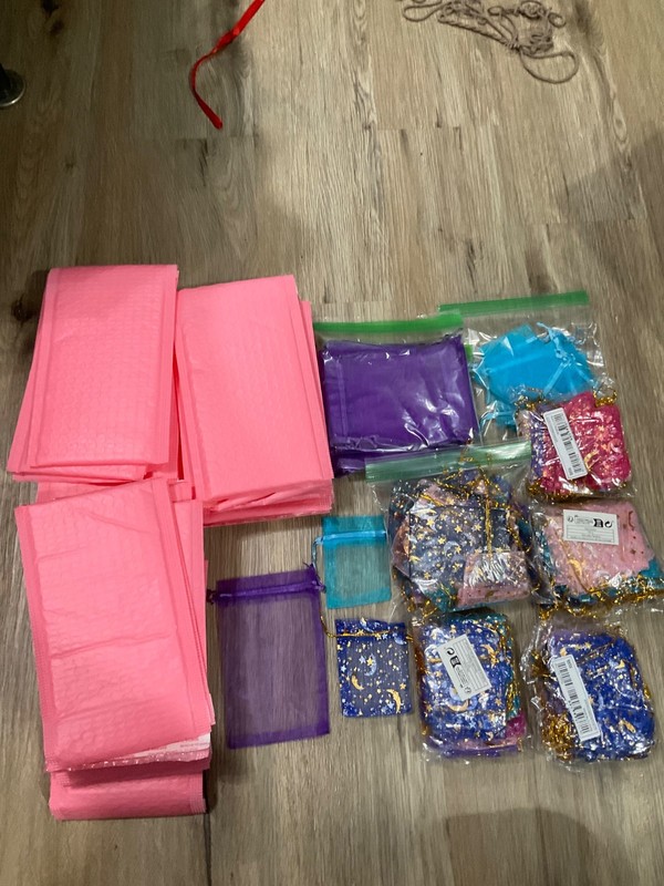 Various packing materials. 5 by 7 pink bubble mailers and mesh drawstring bags